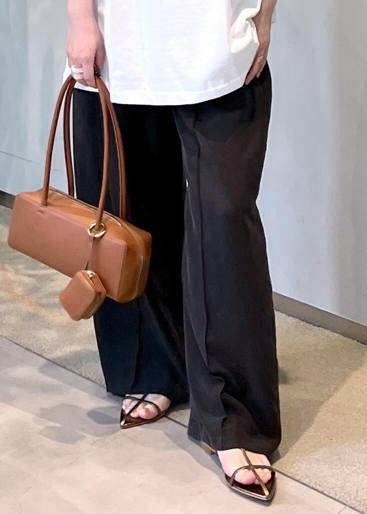 ブラック系のその他パンツ、その他のサンダル、イエロー系のショルダーバッグを着用したレディースの春コーディネートの9枚目の写真