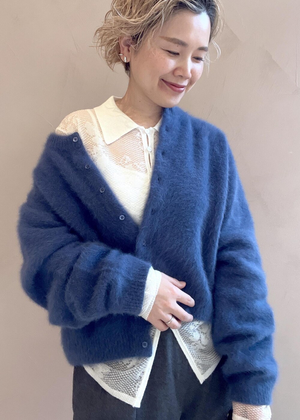 ブラック系のショルダーバッグ、ブルー系のカーディガン/ボレロ、グレー系のスラックスを着用したレディースの冬コーディネートの5枚目の写真