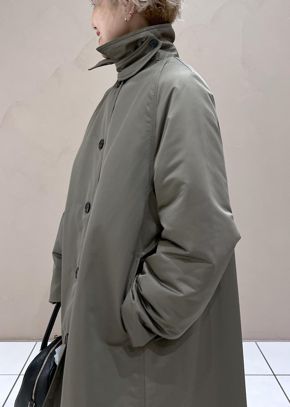 ブラック系のボストンバッグ、グリーン系のダウンジャケット/コート、ブラック系のその他パンツを着用したレディースの秋コーディネートの7枚目の写真