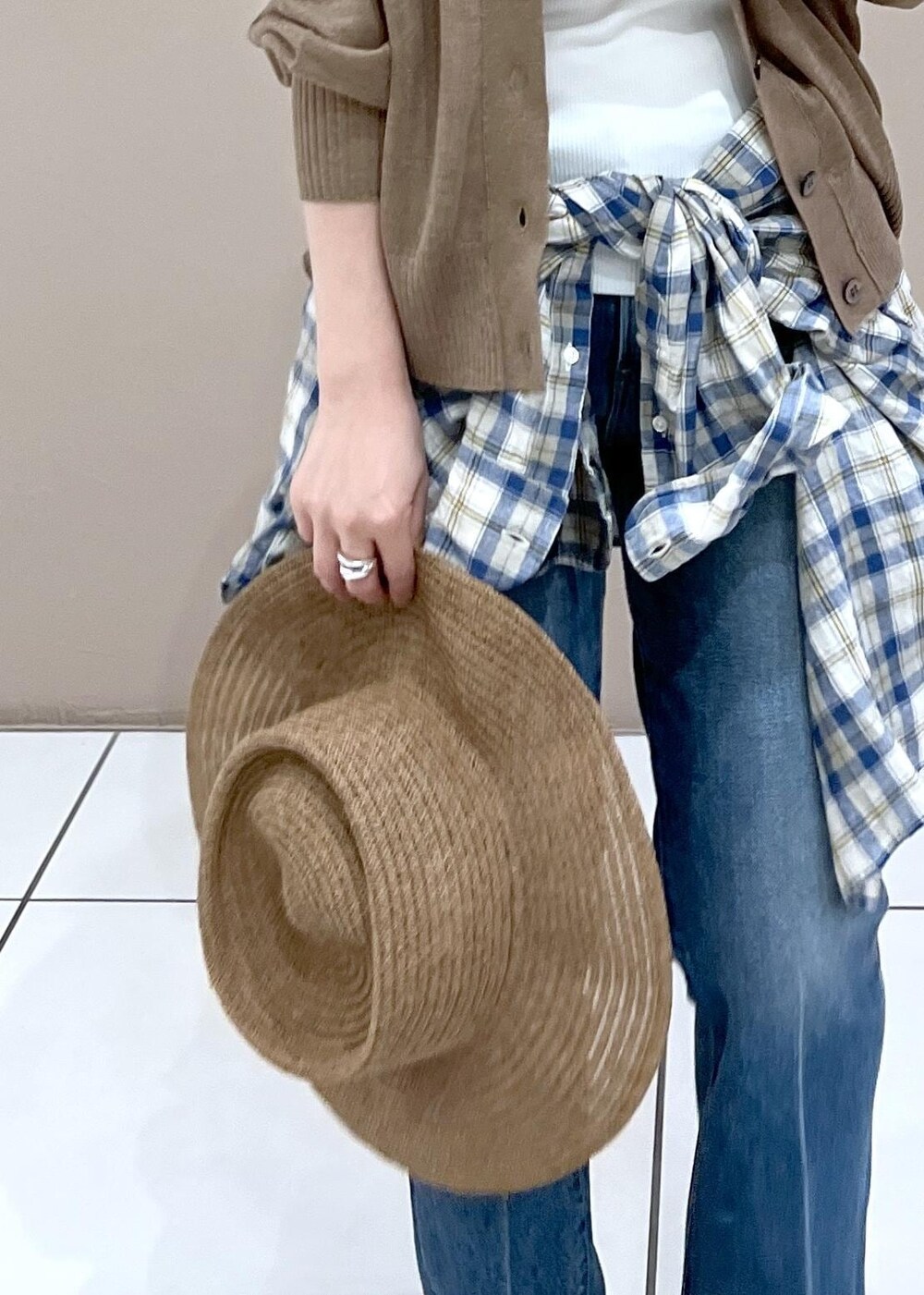 ホワイト系のタンクトップ、ゴールド系のカーディガン/ボレロ、ブルー系のデニムパンツを着用したレディースの夏コーディネートの10枚目の写真