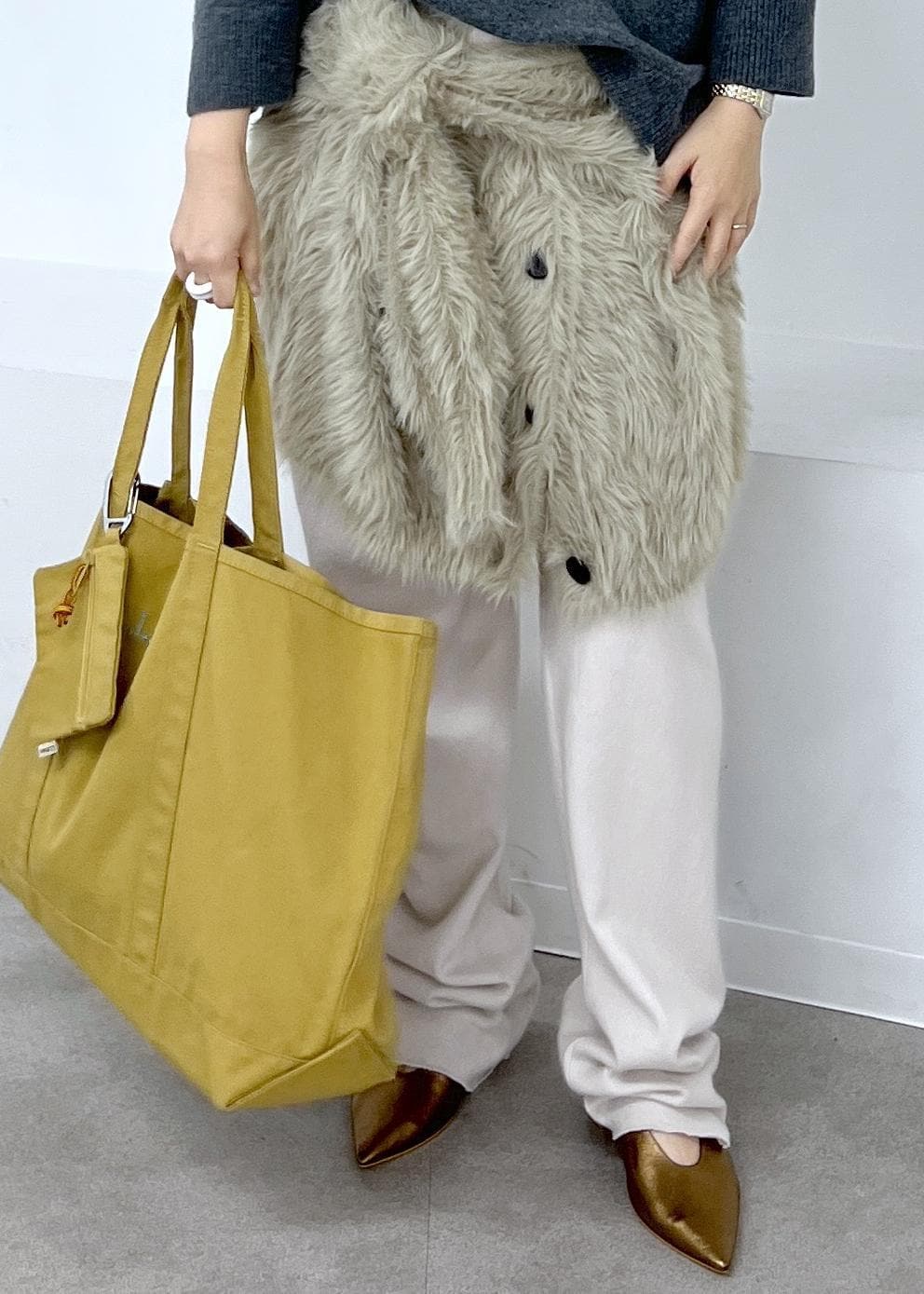 その他のパンプス、ベージュ系のカーディガン/ボレロ、ブラウン系のトートバッグを着用したレディースの秋コーディネートの6枚目の写真