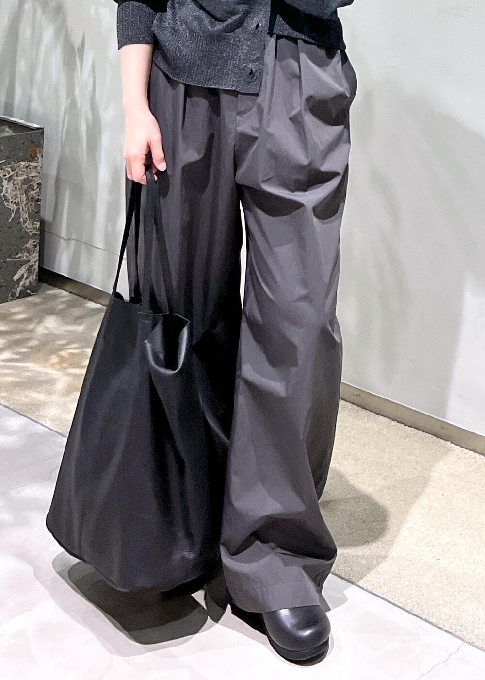 ブラック系のタンクトップ、シルバー系のカーディガン/ボレロ、グレー系のその他パンツを着用したレディースの春コーディネートの9枚目の写真