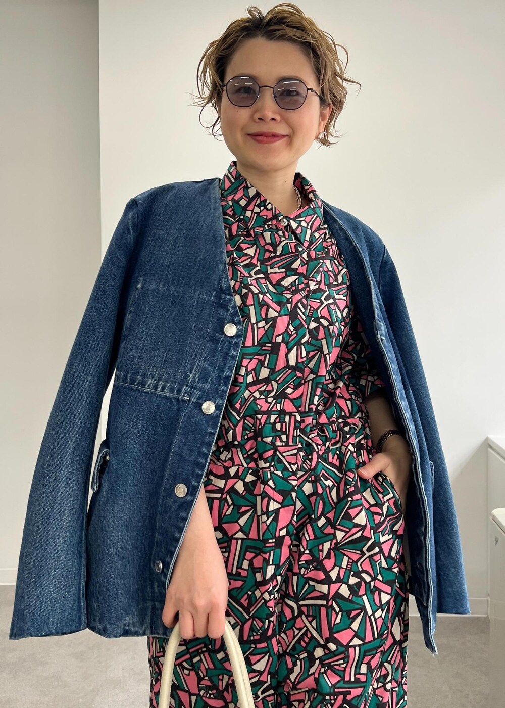 ホワイト系のボストンバッグ、グレー系のサンダル、グリーン系のつなぎ/オールインワンを着用したレディースの春コーディネートの6枚目の写真