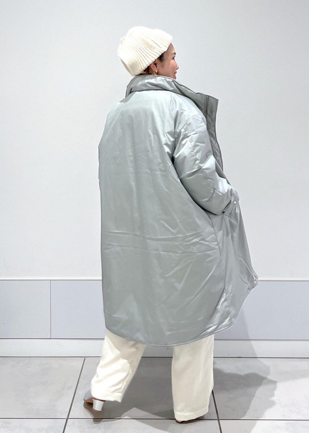 ホワイト系のキャミソール、ホワイト系のカーゴパンツ、シルバー系のその他アウターを着用したレディースの冬コーディネートの6枚目の写真