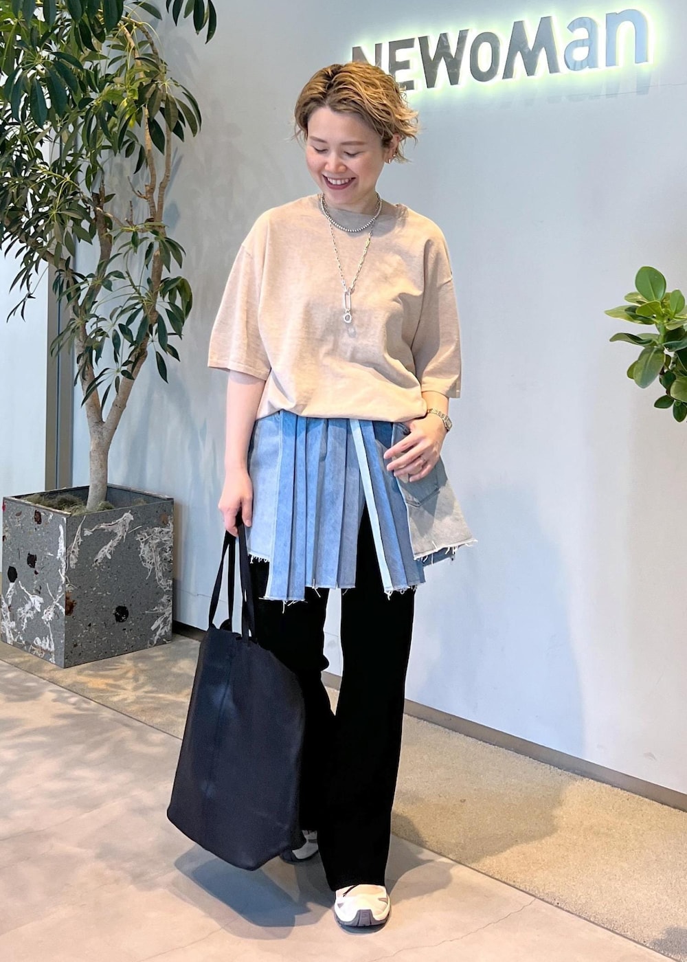 ブラック系のその他パンツ、ベージュ系のTシャツ/カットソー、ベージュ系のスニーカーを着用したレディースの春コーディネートの2枚目の写真