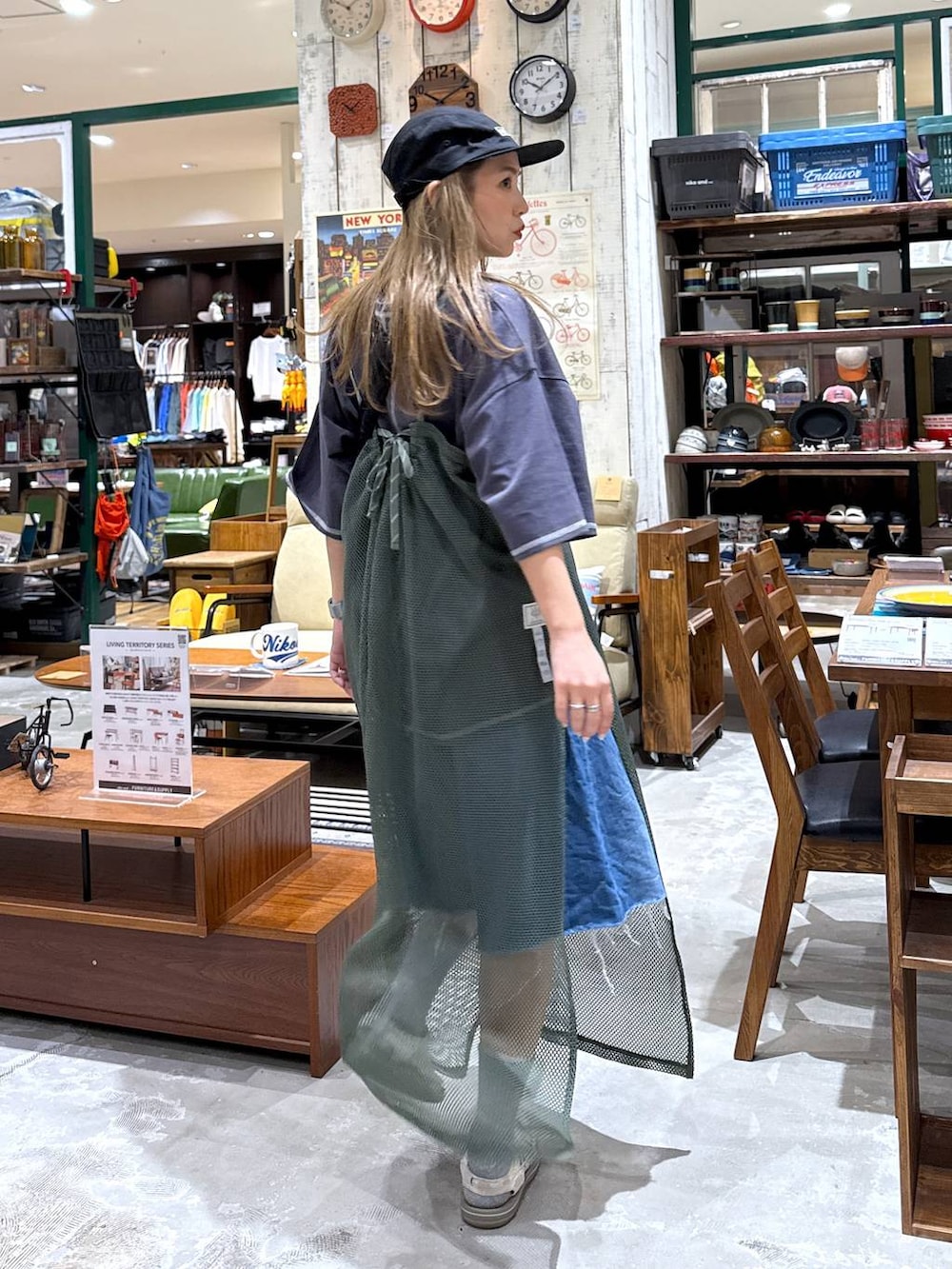 ブルー系のデニムパンツ、ブラック系のキャップを着用したレディースの春コーディネートの4枚目の写真