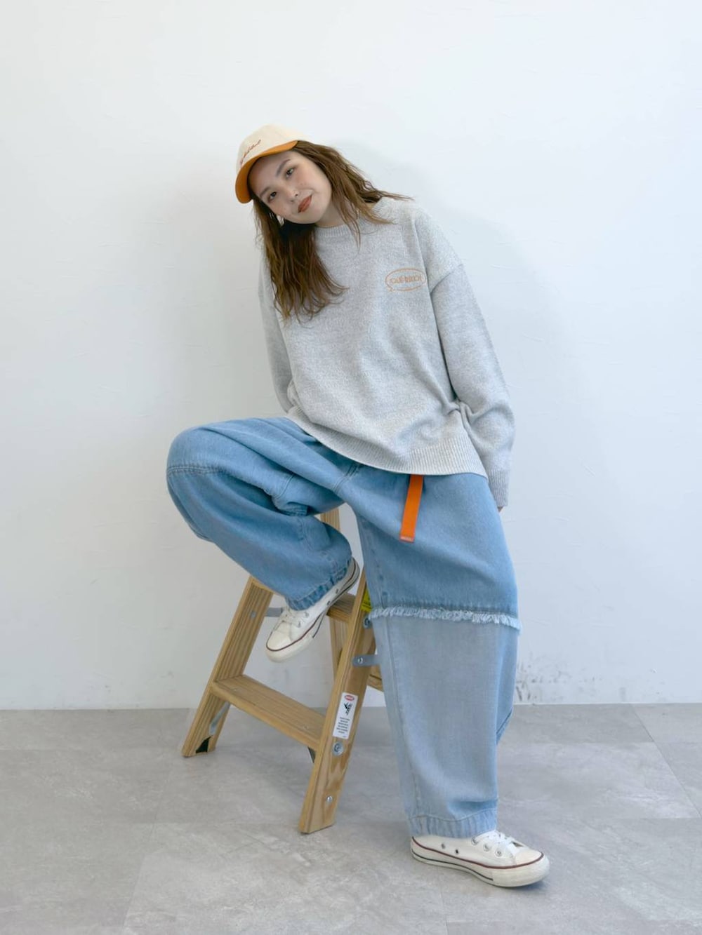 ブルー系のデニムパンツ、グレー系のニット/セーターを着用したレディースの冬コーディネートの2枚目の写真