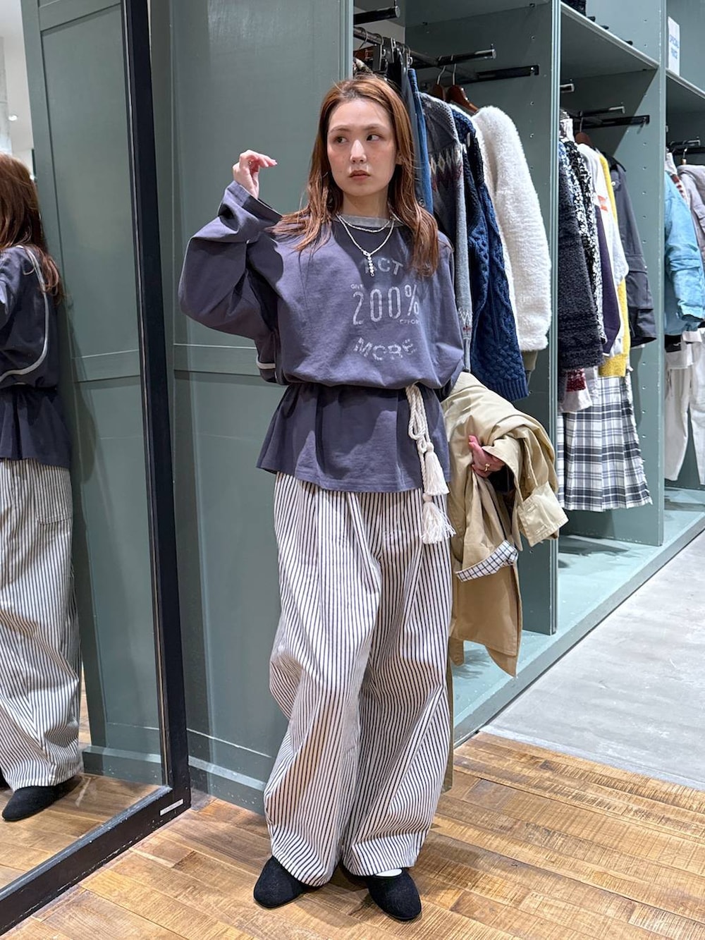 ブラック系のパンプス、ベージュ系のトレンチコートを着用したレディースの春コーディネートの2枚目の写真