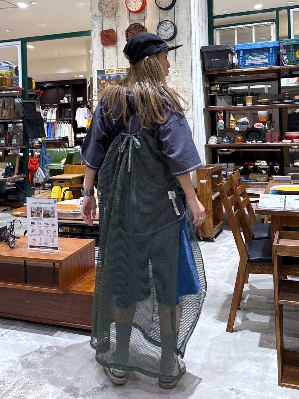 ブルー系のデニムパンツ、ブラック系のキャップを着用したレディースの春コーディネートの3枚目の写真