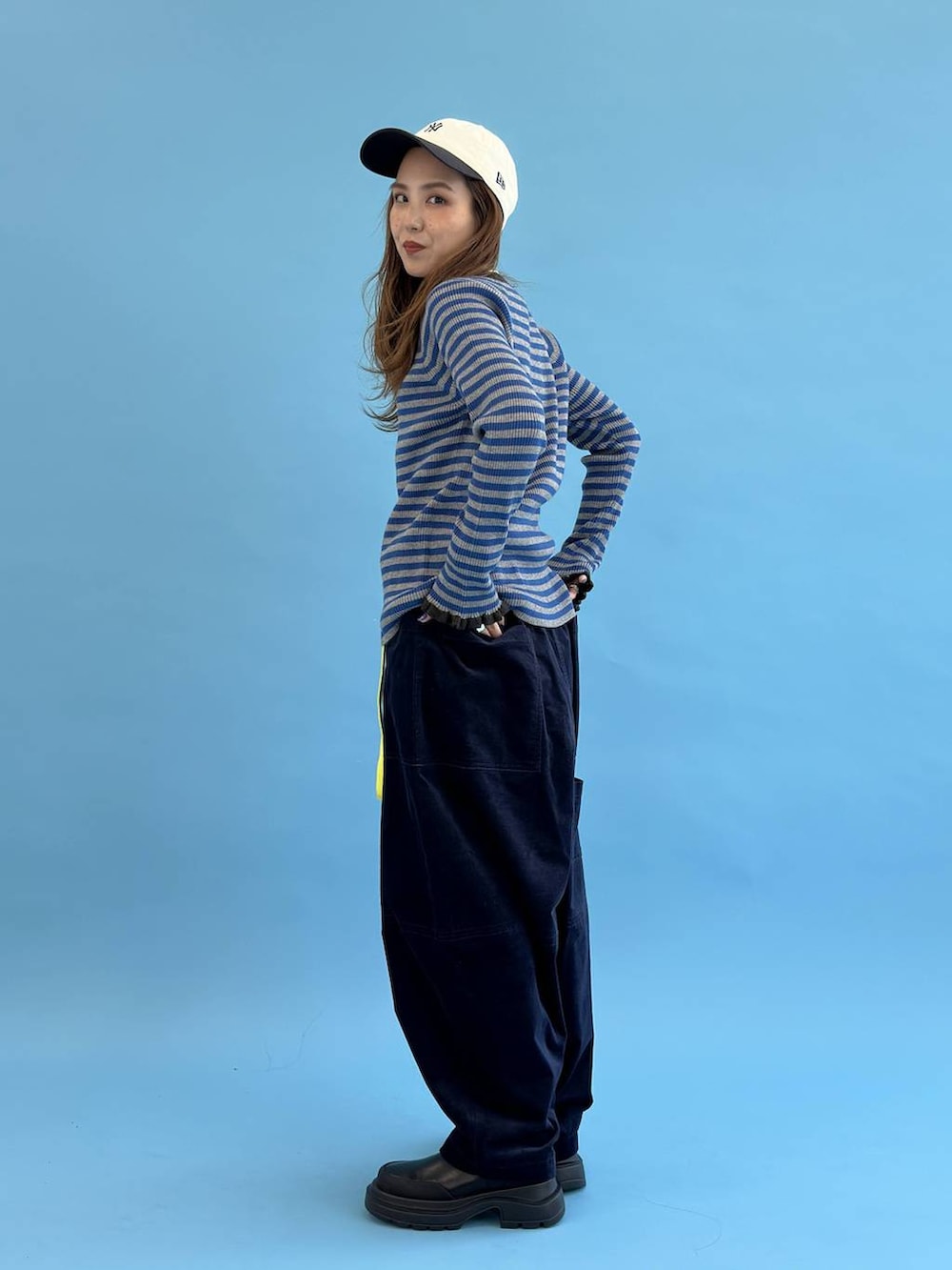 ブルー系のその他パンツ、ブルー系のニット/セーター、イエロー系のベルトを着用したレディースの秋コーディネートの4枚目の写真