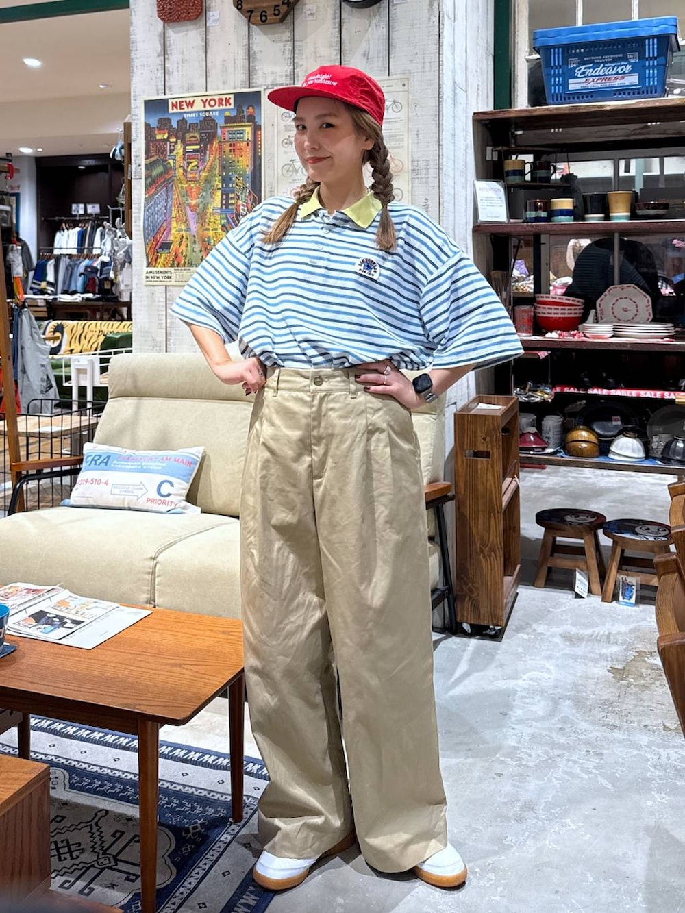 ベージュ系のチノパンツ、ブルー系のポロシャツを着用したレディースの夏コーディネートの2枚目の写真