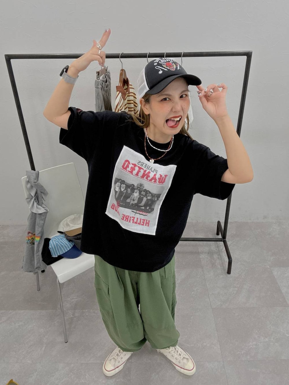 グリーン系のカーゴパンツ、ブラック系のTシャツ/カットソー、ブラック系のキャップを着用したレディースの夏コーディネートの3枚目の写真