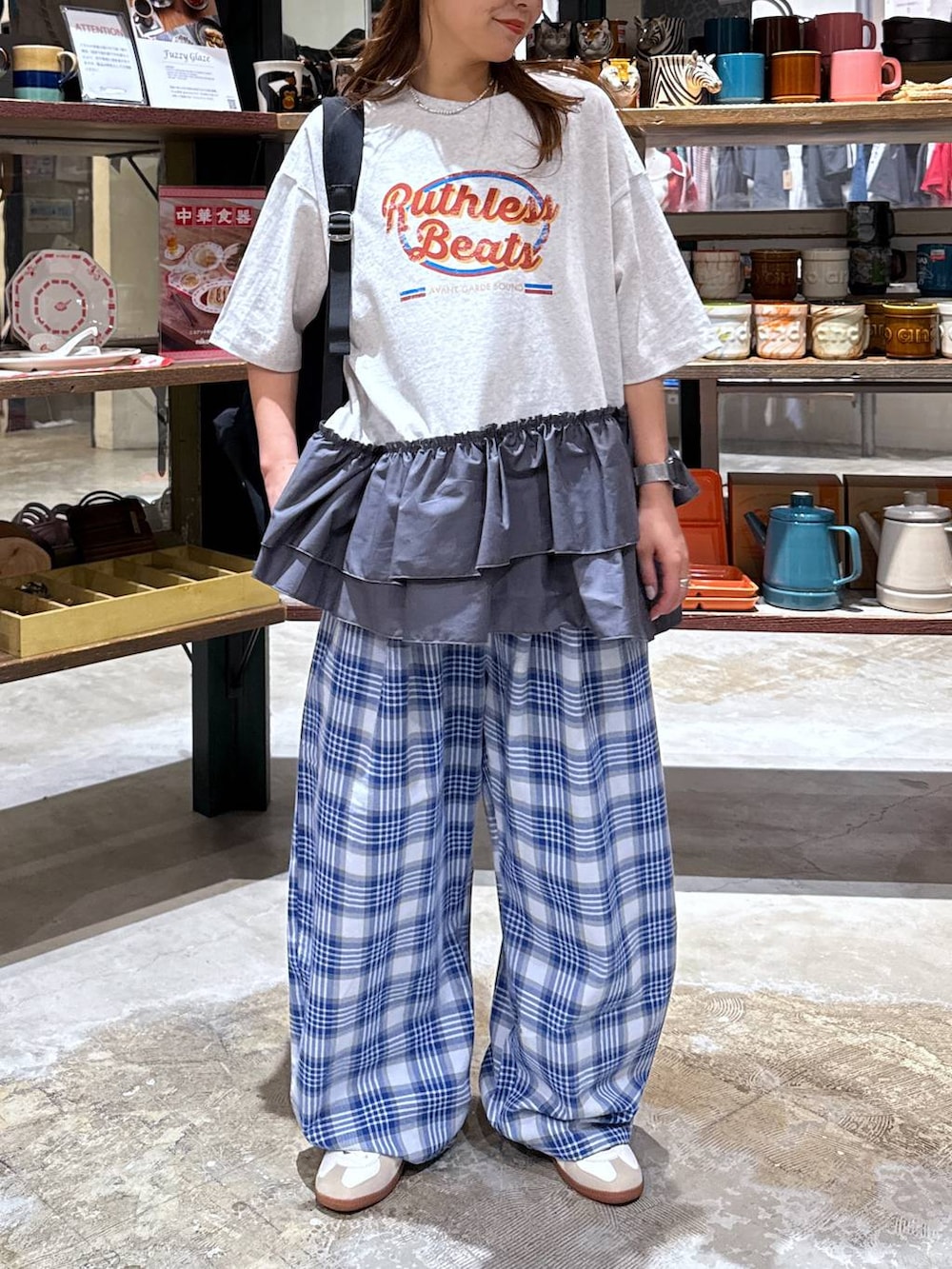 ベージュ系のスニーカー、ブラック系のバックパック/リュック、グレー系のTシャツ/カットソーを着用したレディースの春コーディネートの4枚目の写真