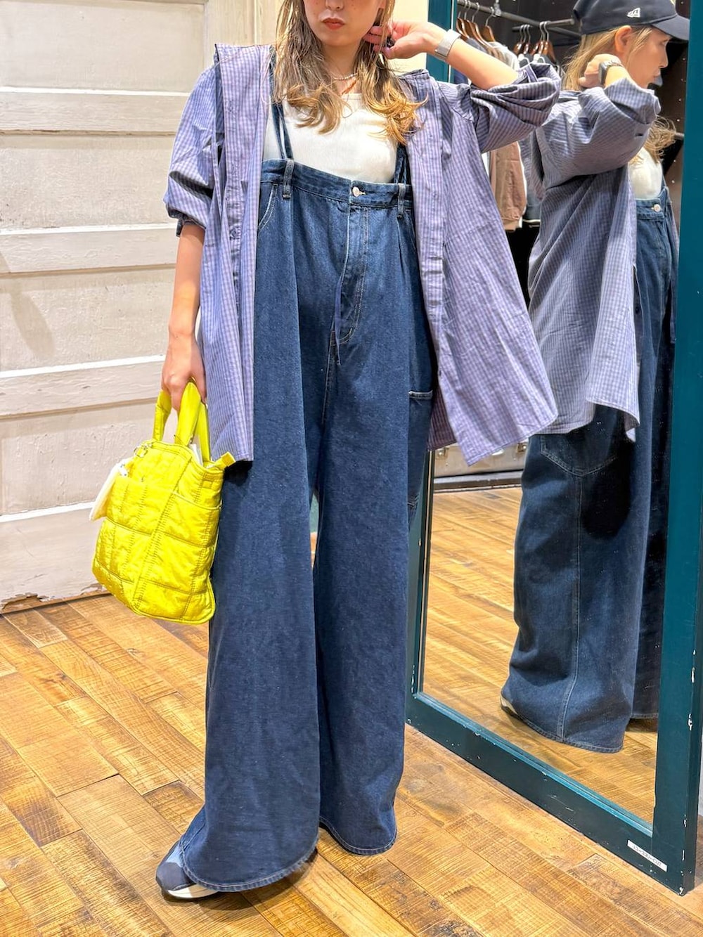 ベージュ系のタンクトップ、イエロー系のトートバッグを着用したレディースの秋コーディネートの2枚目の写真