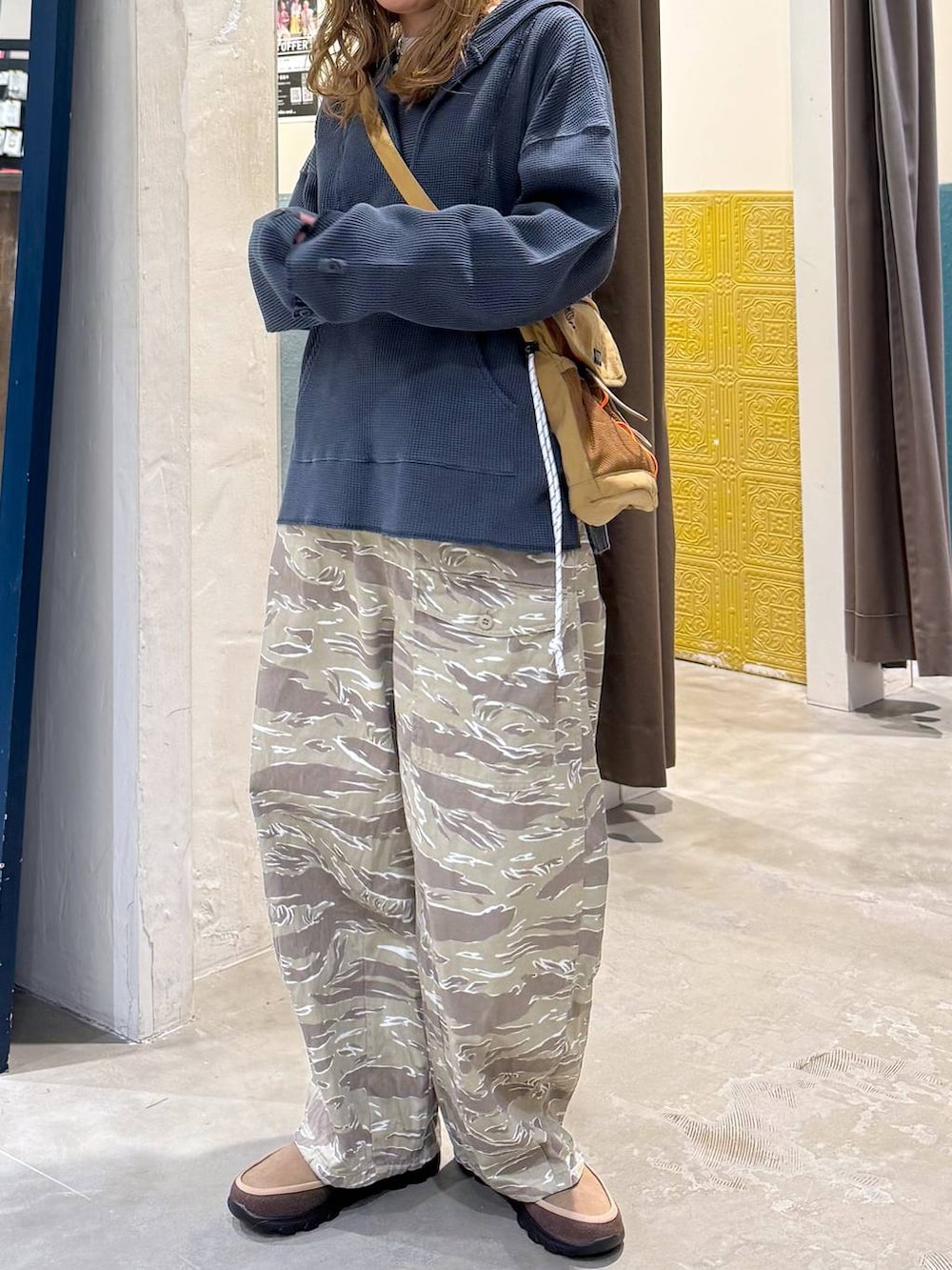 ブルー系のパーカー、ベージュ系のその他シューズ、ブラウン系のキャップを着用したレディースの冬コーディネートの3枚目の写真