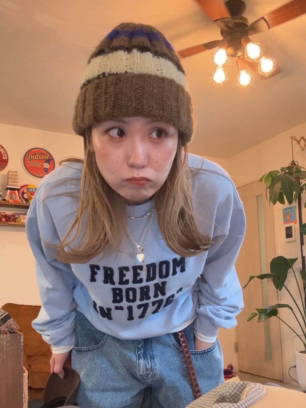 ブラウン系のテーラードジャケット、ブルー系のスウェット、ブラウン系のニットキャップ/ビーニーを着用したレディースの冬コーディネートの3枚目の写真