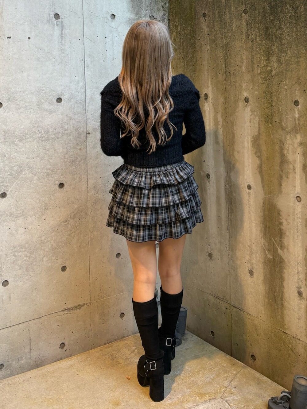 ブラック系のブーツ、ブラック系のスカート、ブラック系のニット/セーターを着用したレディースの冬コーディネートの3枚目の写真