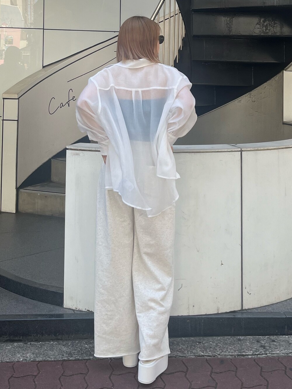 ホワイト系のスウェットパンツ、ホワイト系のサンダル、ブルー系のキャミソールを着用したレディースの春コーディネートの3枚目の写真