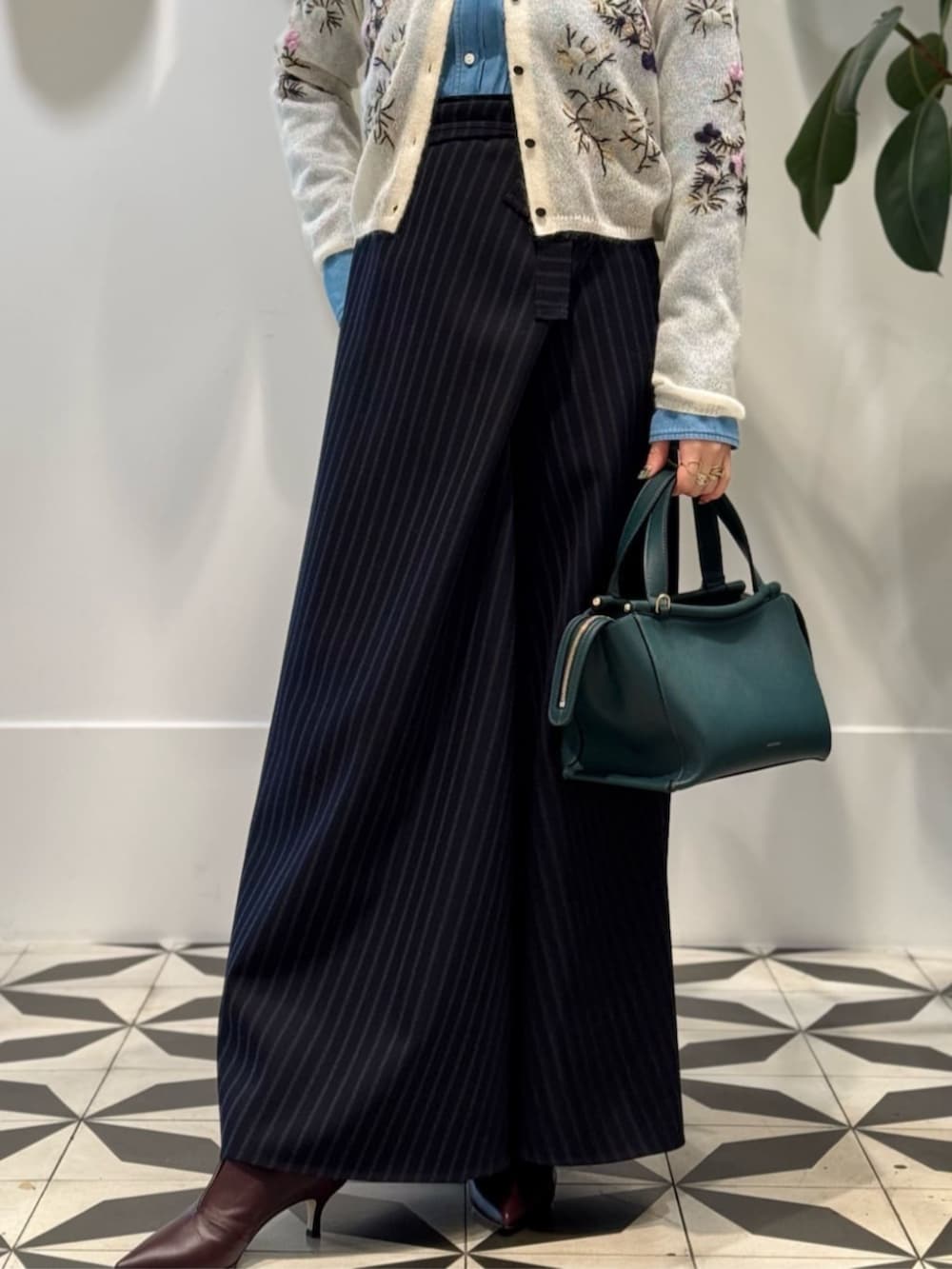 レッド系のパンプス、ブルー系のシャツ/ブラウス、ホワイト系のカーディガン/ボレロを着用したレディースの秋コーディネートの4枚目の写真