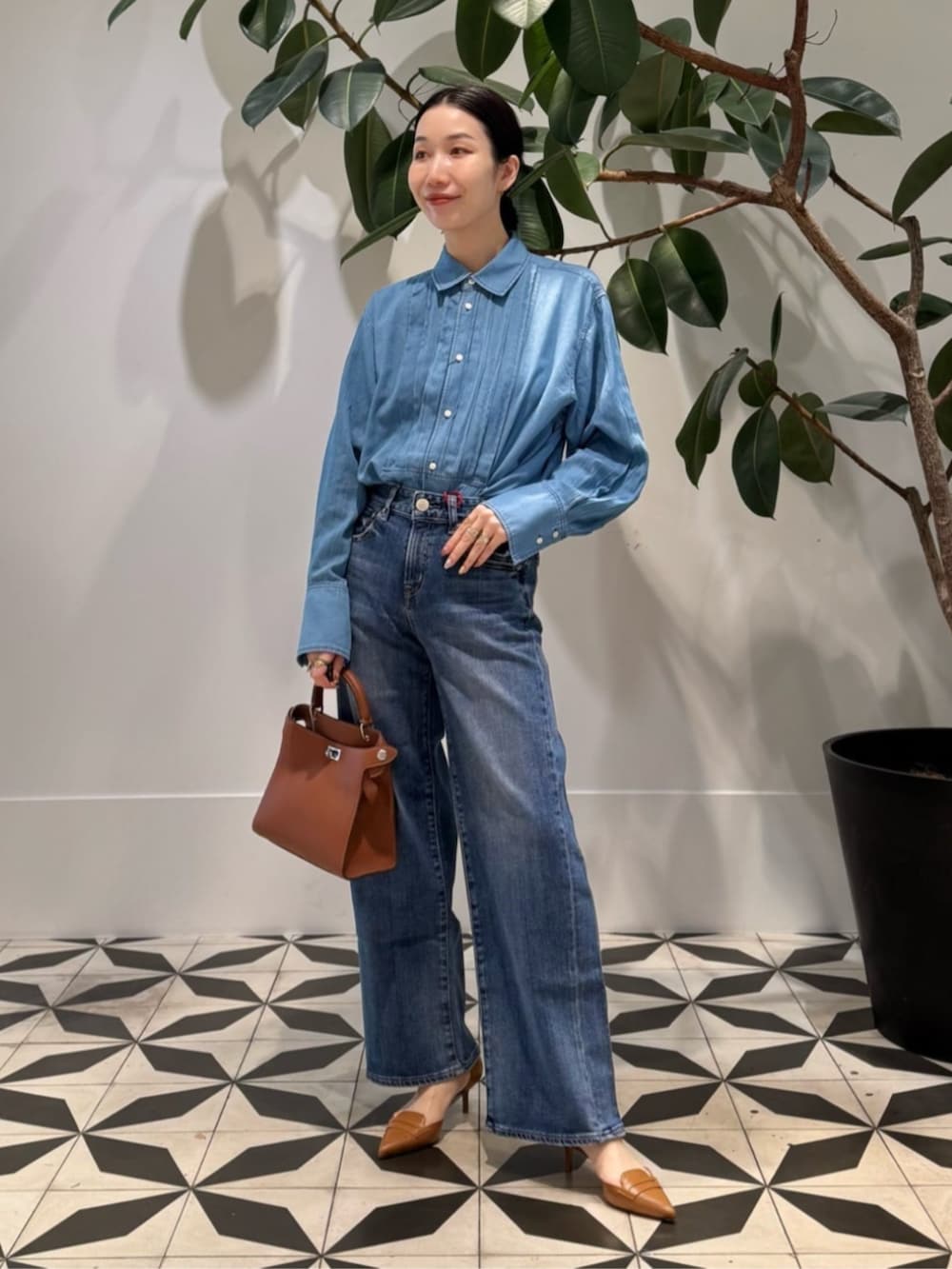 ホワイト系のキャミソール、ブルー系のデニムパンツ、レッド系のノーカラージャケットを着用したレディースの秋コーディネートの2枚目の写真