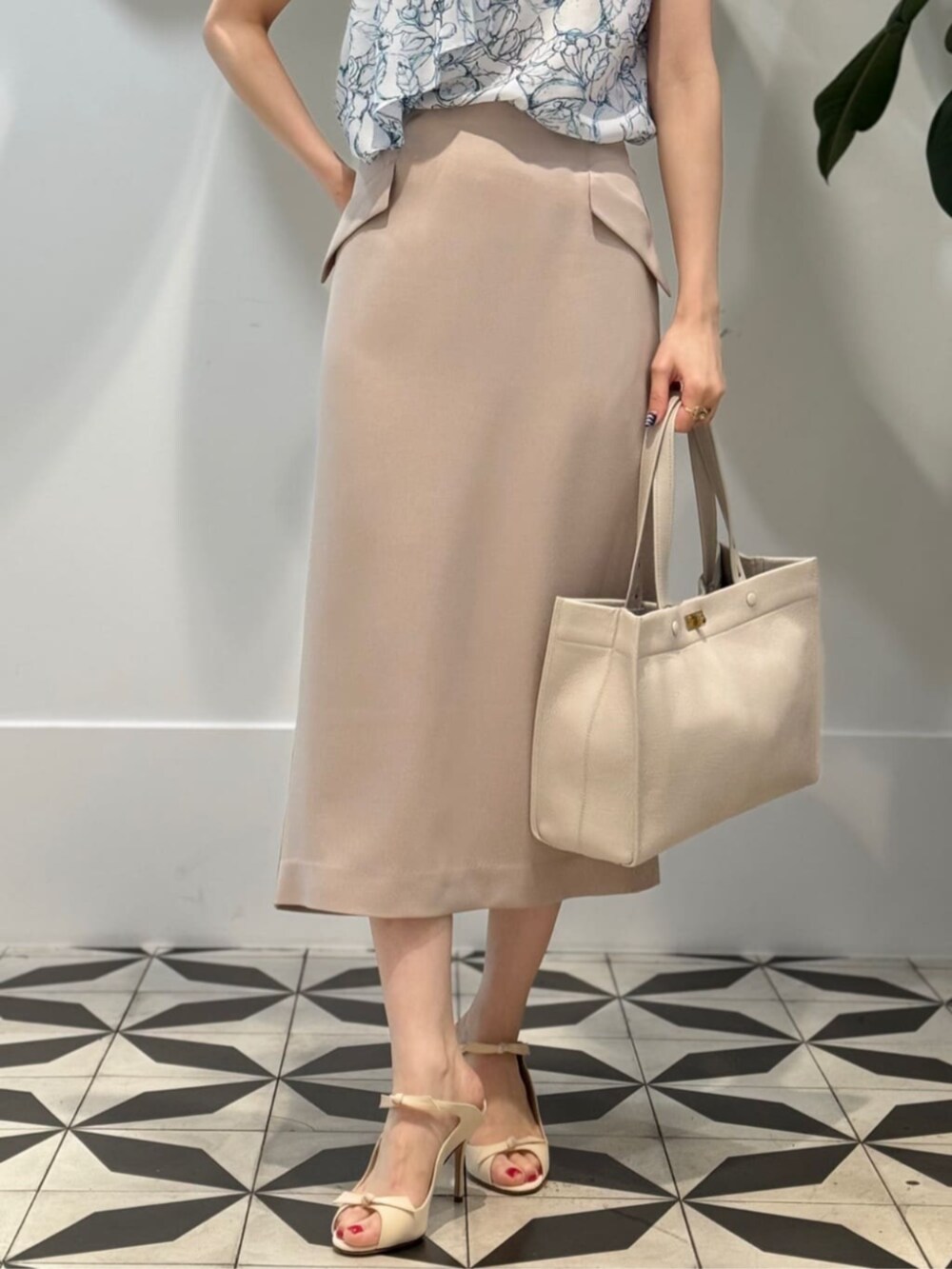 ホワイト系のキャミソール、ホワイト系のシャツ/ブラウス、ベージュ系のスカートを着用したレディースの夏コーディネートの3枚目の写真