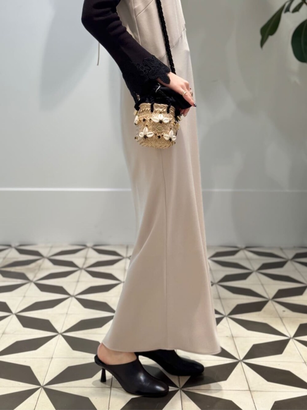 ブラック系のキャミソール、ベージュ系のワンピース、ブラック系のサンダルを着用したレディースの夏コーディネートの3枚目の写真