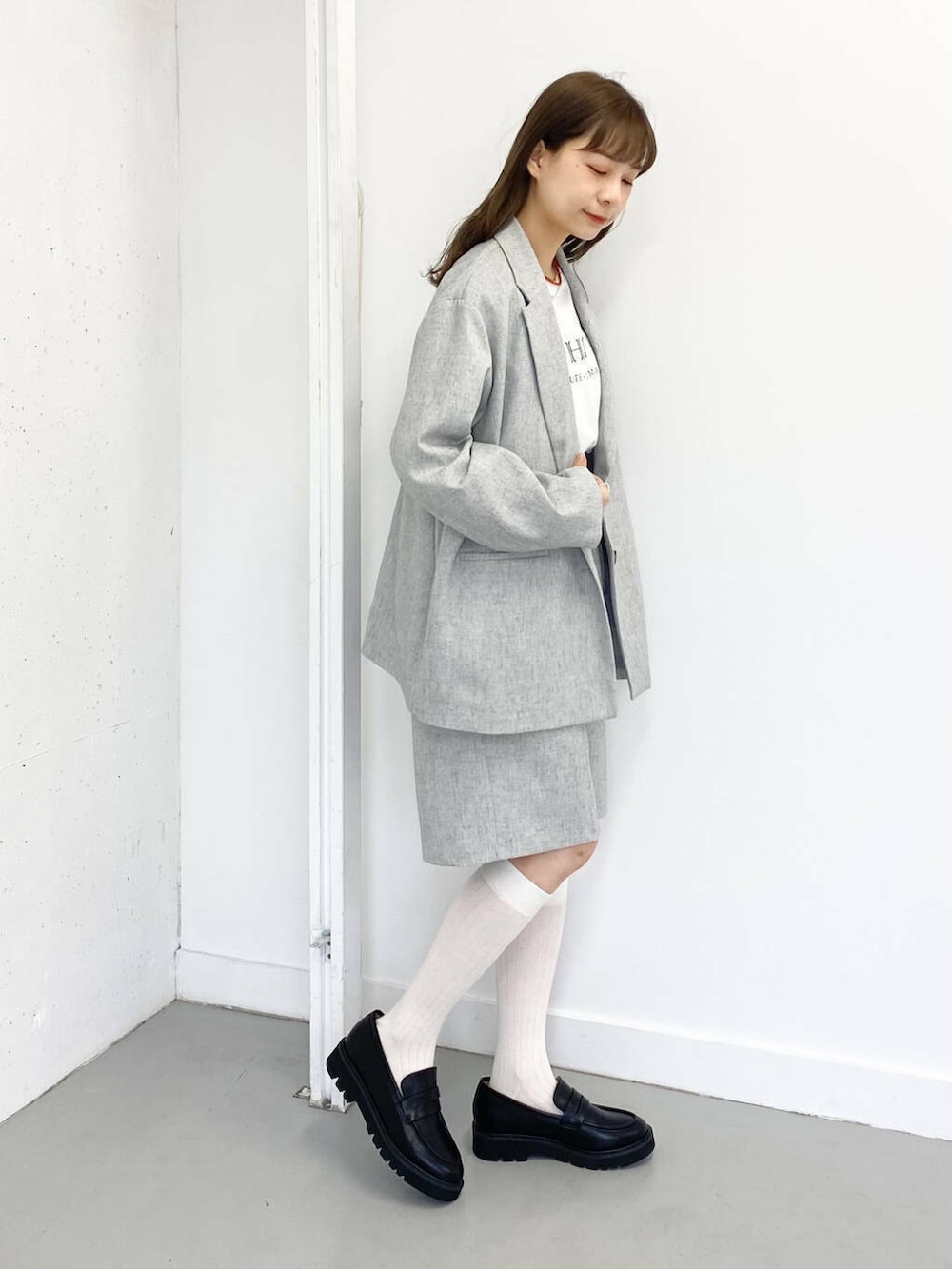 ブラック系のローファー、グレー系のその他パンツ、レッド系のネックレスを着用したレディースの春コーディネートの4枚目の写真