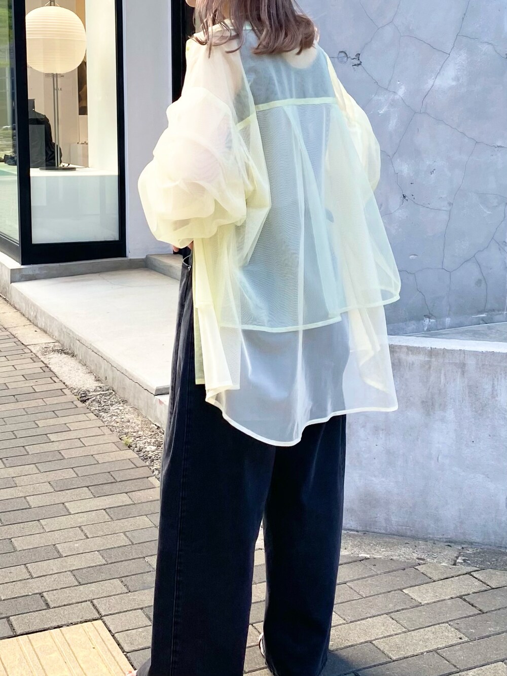 グレー系のタンクトップ、グリーン系のシャツ/ブラウス、ブラック系のデニムパンツを着用したレディースの夏コーディネートの2枚目の写真