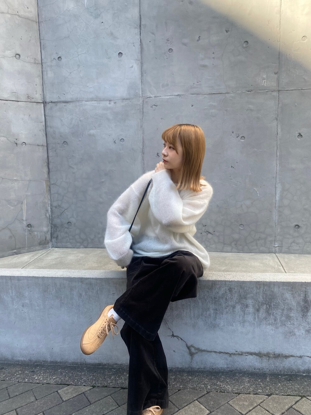 グレー系のその他パンツ、ホワイト系のニット/セーター、ベージュ系のスニーカーを着用したレディースの秋コーディネートの7枚目の写真