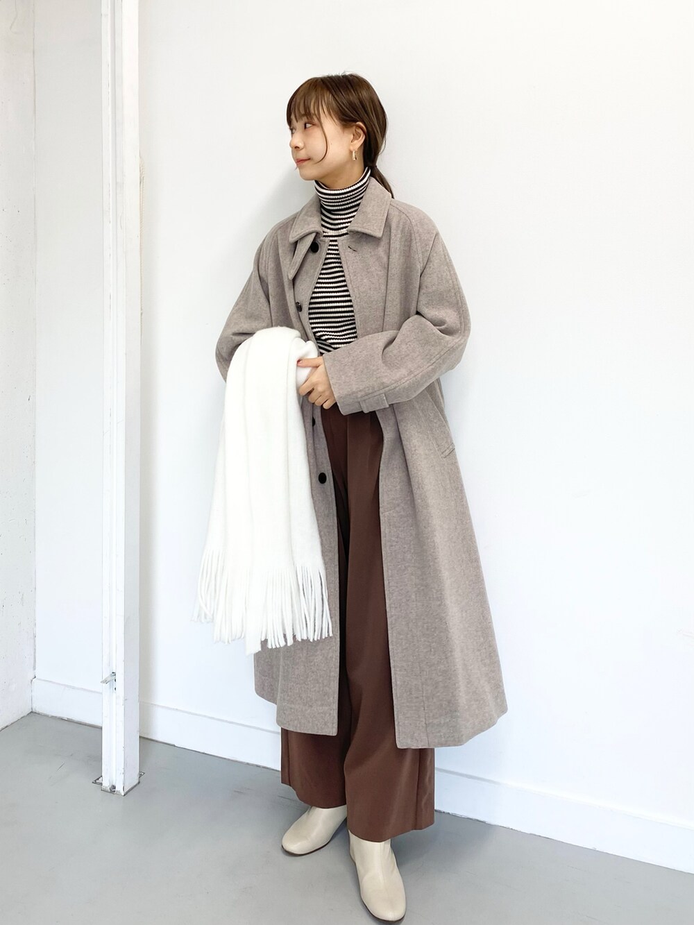 ホワイト系のブーツ、ブラウン系のその他パンツ、その他のニット/セーターを着用したレディースの冬コーディネートの3枚目の写真