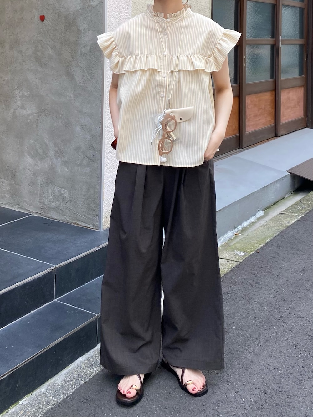 ベージュ系のシャツ/ブラウス、グレー系のその他パンツ、ブラウン系のサンダルを着用したレディースの夏コーディネートの7枚目の写真