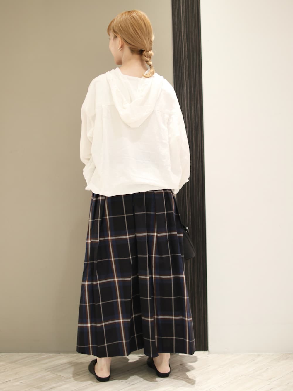 グリーン系のスカート、ブラック系のサンダル、ブラック系のショルダーバッグを着用したレディースの秋コーディネートの3枚目の写真