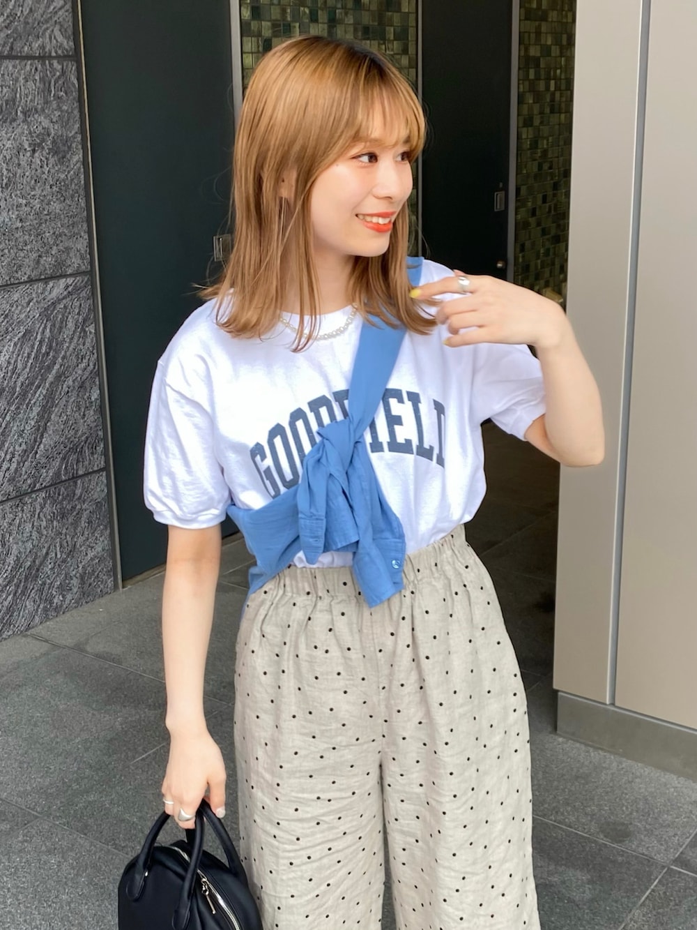 ブラック系のサンダル、ブラック系のボストンバッグ、ベージュ系のその他パンツを着用したレディースの夏コーディネートの3枚目の写真