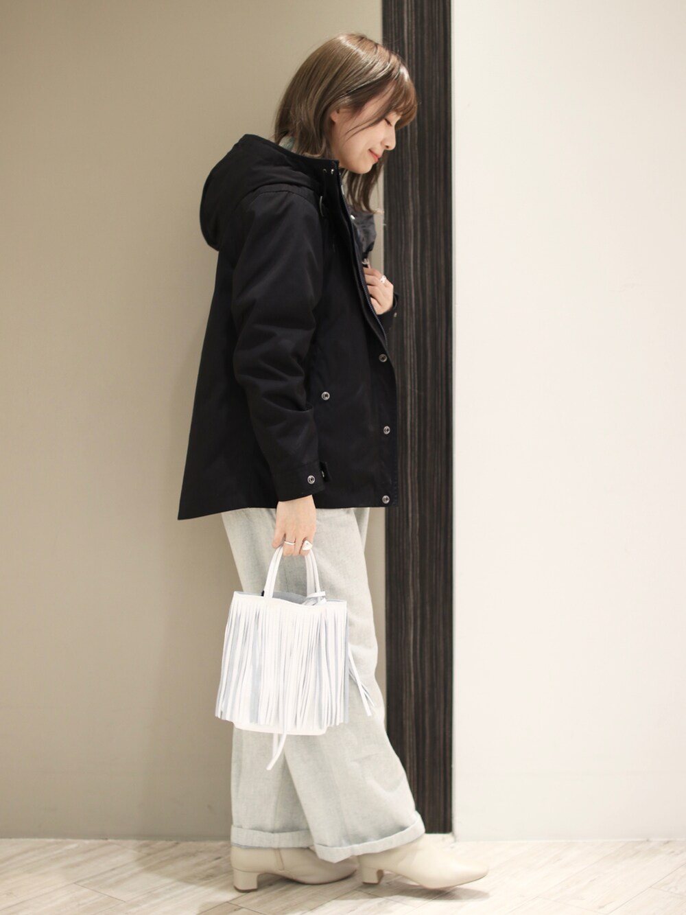 ブルー系のサロペット/オーバーオール、グリーン系のニット/セーター、ブルー系のマウンテンパーカーを着用したレディースの冬コーディネートの3枚目の写真