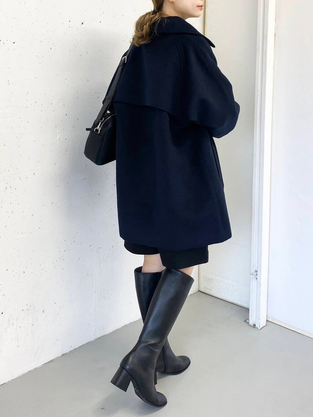 ブラック系のショルダーバッグ、ベージュ系のニット/セーター、ブラック系のその他パンツを着用したレディースの冬コーディネートの4枚目の写真