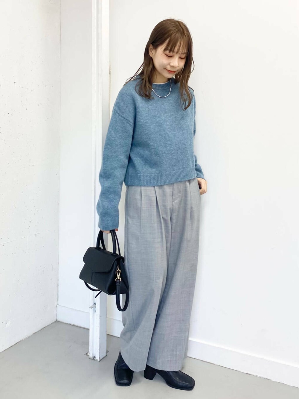 ブラック系のショルダーバッグ、グレー系のその他パンツ、ブラック系のブーツを着用したレディースの冬コーディネートの8枚目の写真