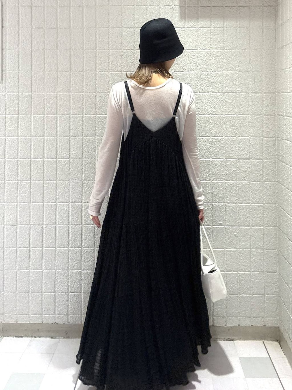 ホワイト系のTシャツ/カットソー、ホワイト系のショルダーバッグ、ブラック系のワンピースを着用したレディースの春コーディネートの4枚目の写真