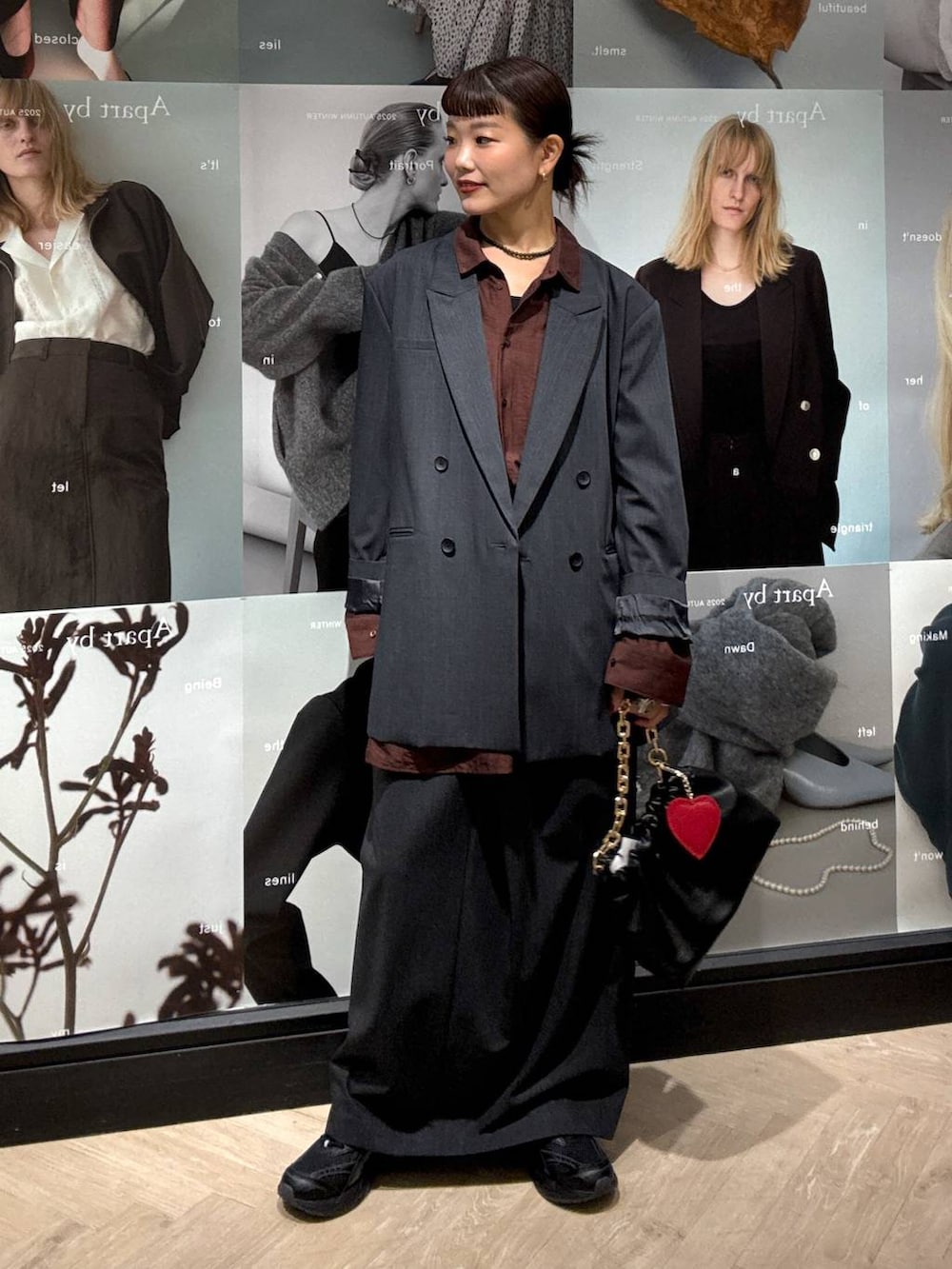 ブラック系のショルダーバッグ、グレー系のスカート、グレー系のテーラードジャケットを着用したレディースの秋コーディネートの5枚目の写真