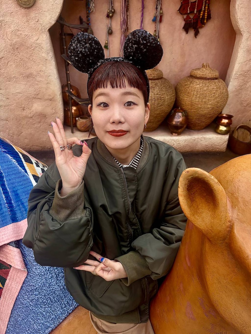 グリーン系のMA-1、ベージュ系のその他パンツを着用したレディースの冬コーディネートの2枚目の写真