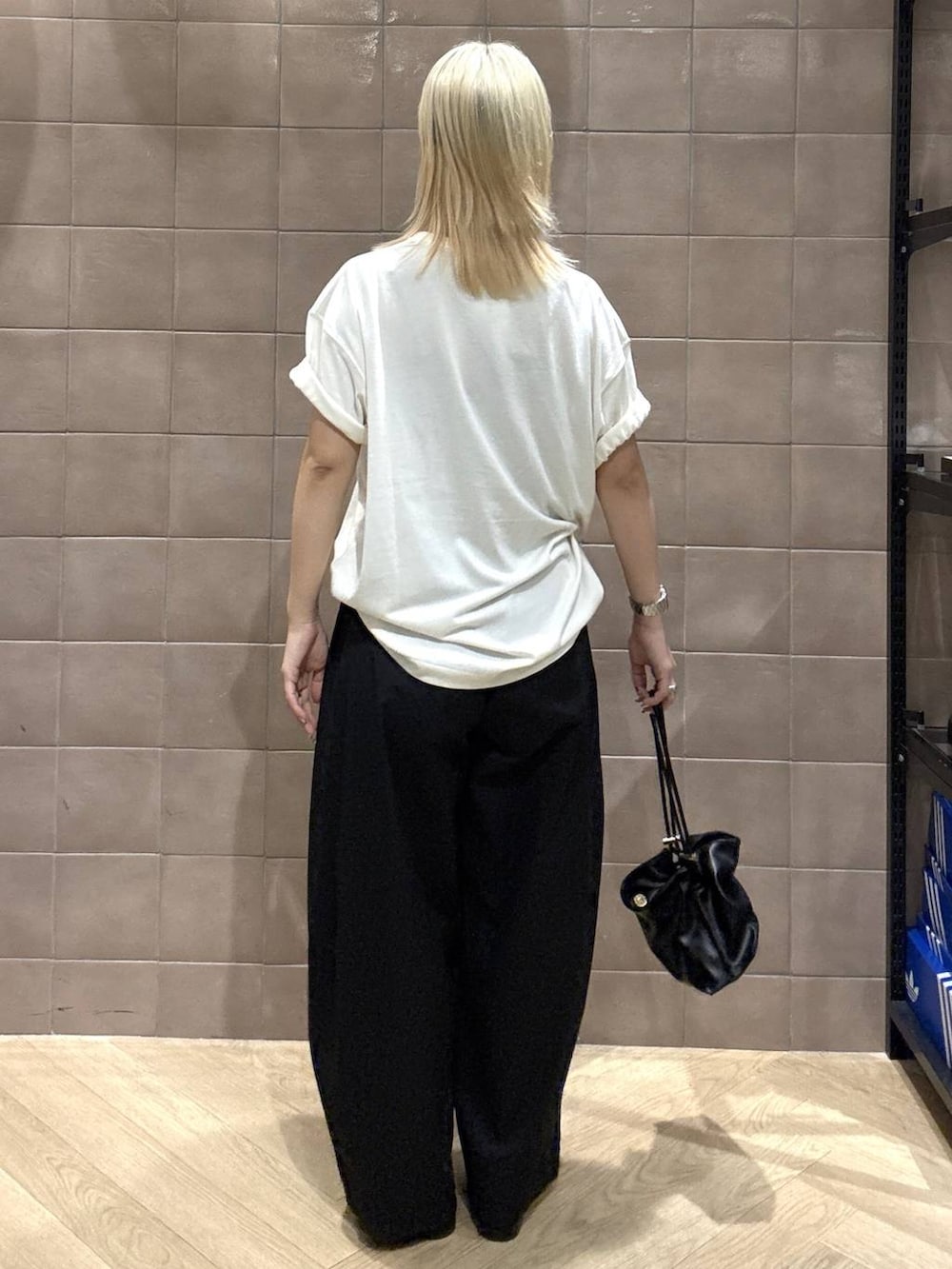 ブラック系のショルダーバッグ、ホワイト系のTシャツ/カットソー、ブラック系のサンダルを着用したレディースの夏コーディネートの5枚目の写真