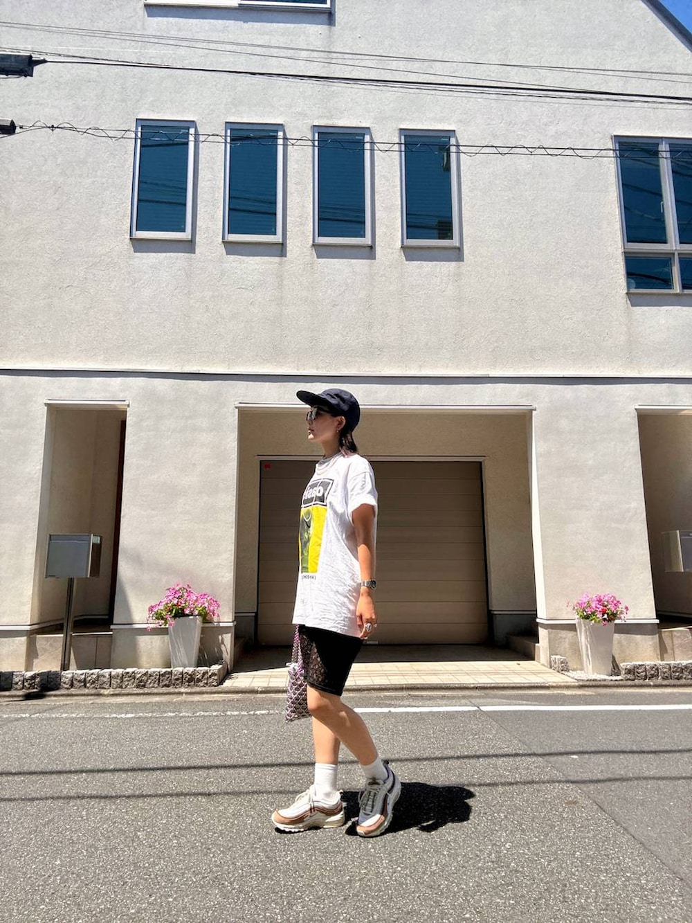 ブラック系のその他パンツ、ブラウン系のサングラスを着用したレディースの夏コーディネートの2枚目の写真