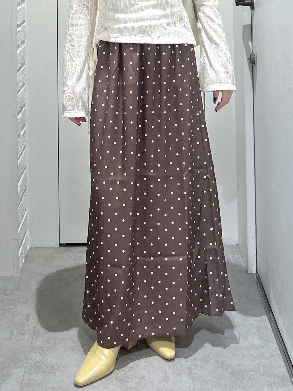 ホワイト系のショルダーバッグ、ホワイト系のTシャツ/カットソー、ベージュ系のパンプスを着用したレディースの秋コーディネートの5枚目の写真