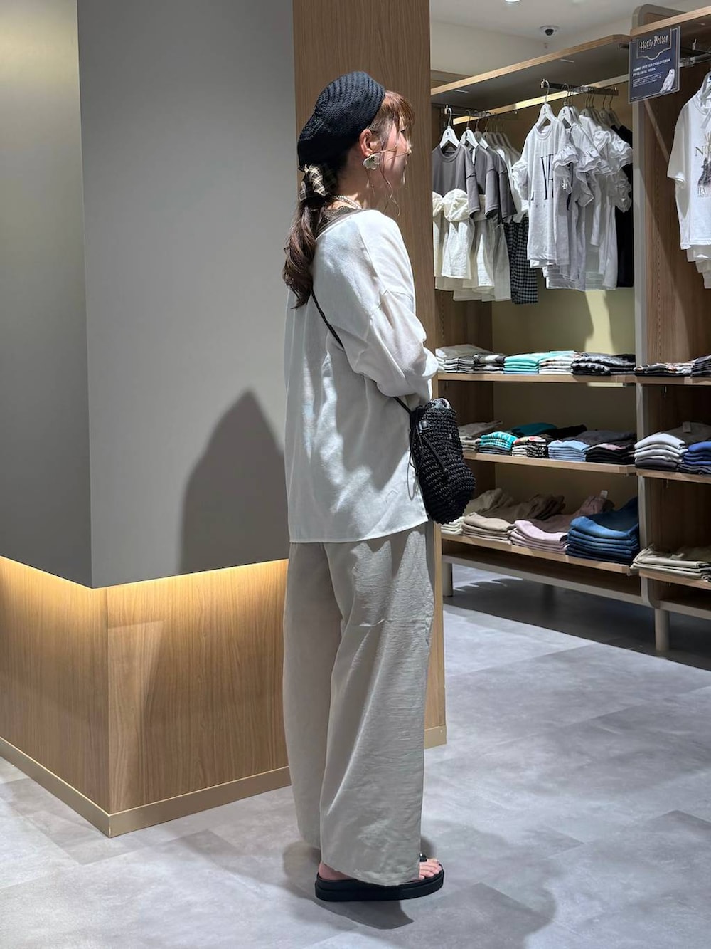 ベージュ系のその他パンツ、ホワイト系のカーディガン/ボレロ、シルバー系のネックレスを着用したレディースの夏コーディネートの3枚目の写真
