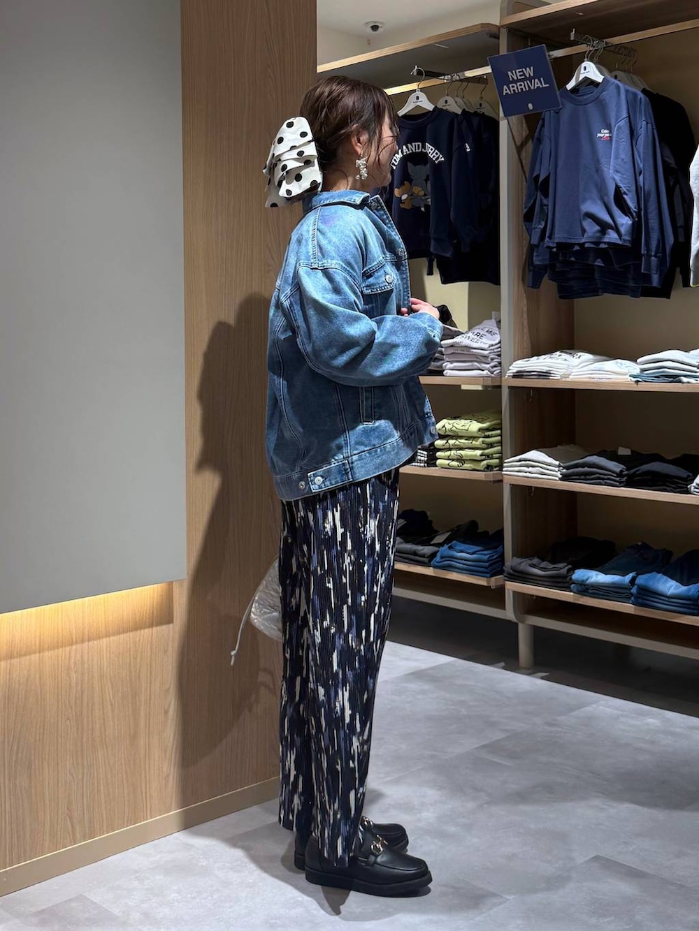 ブラック系のローファー、シルバー系のハンドバッグ、ブルー系のデニムジャケットを着用したレディースの春コーディネートの3枚目の写真