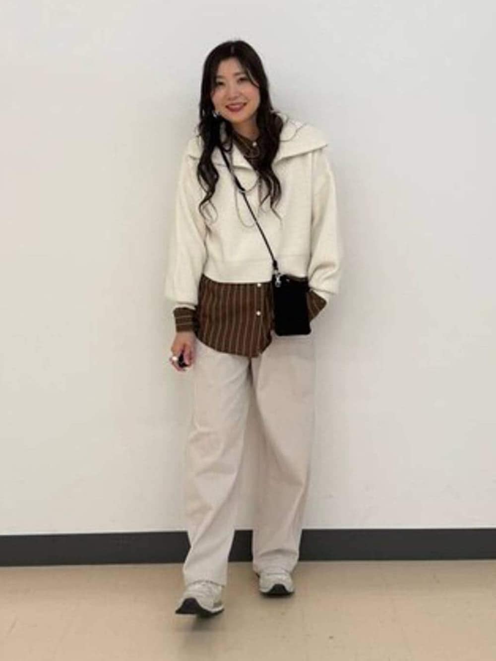 ブラウン系のシャツ/ブラウス、グレー系のその他パンツ、ホワイト系のニット/セーターを着用したレディースの冬コーディネートの2枚目の写真