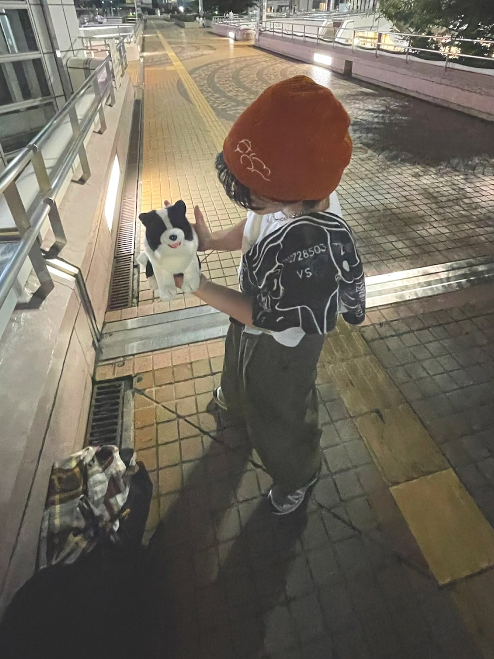 ブラック系のバックパック/リュック、グリーン系のチノパンツ、グレー系のスニーカーを着用したレディースの秋コーディネートの2枚目の写真