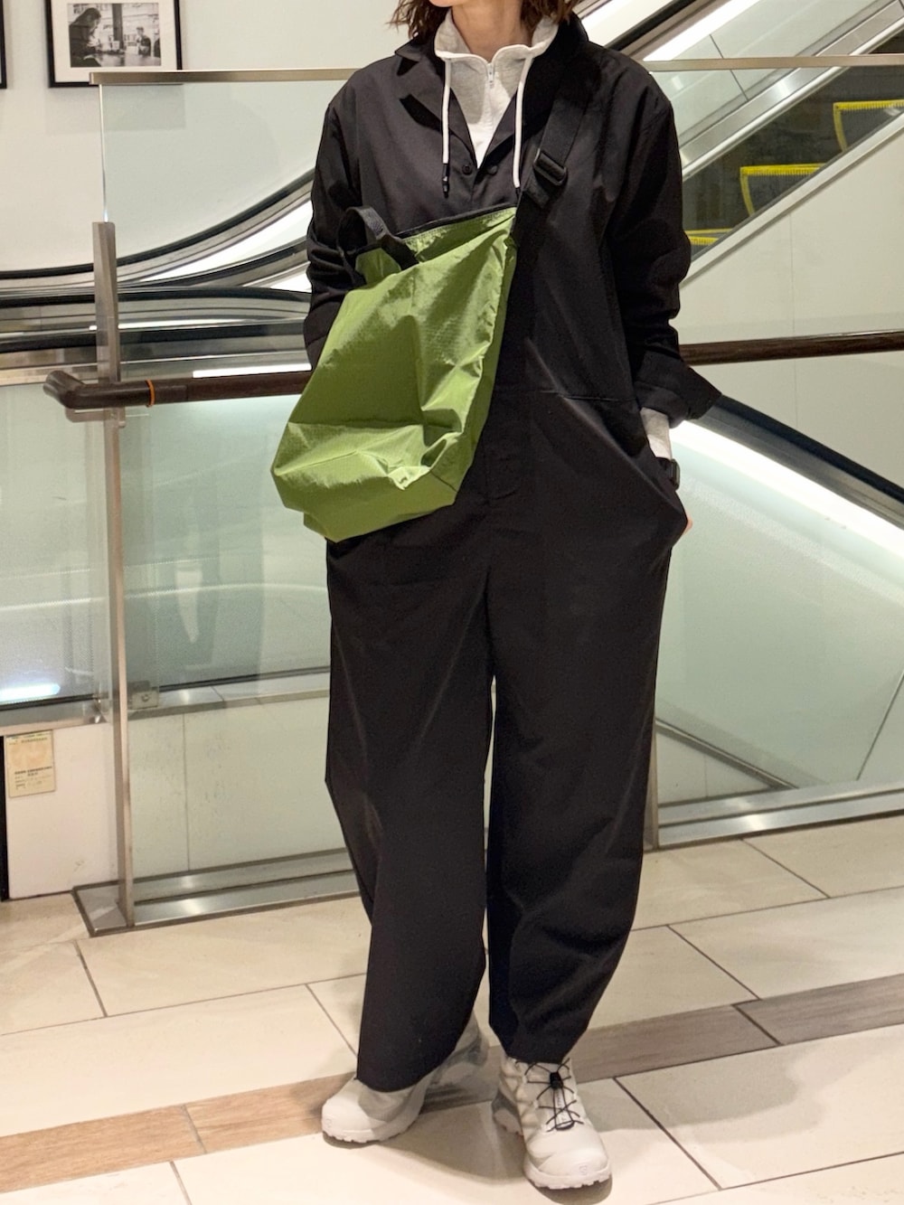 ブラック系のサロペット/オーバーオール、ホワイト系のスウェット、シルバー系のスニーカーを着用したレディースの冬コーディネートの2枚目の写真