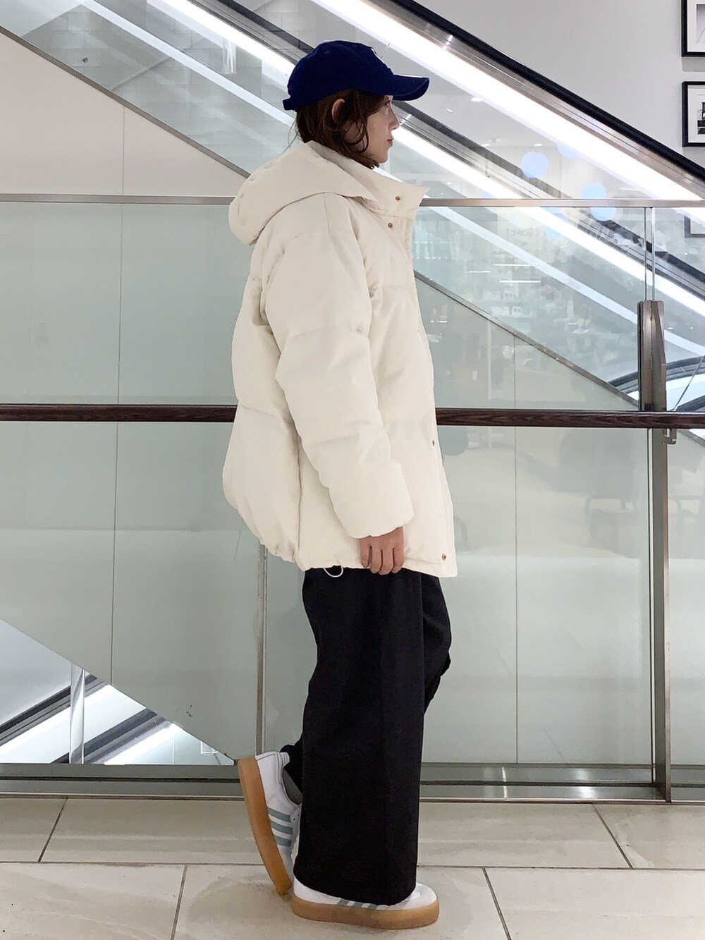 グレー系のその他パンツ、グレー系のその他トップス、ホワイト系のダウンジャケット/コートを着用したレディースの冬コーディネートの2枚目の写真