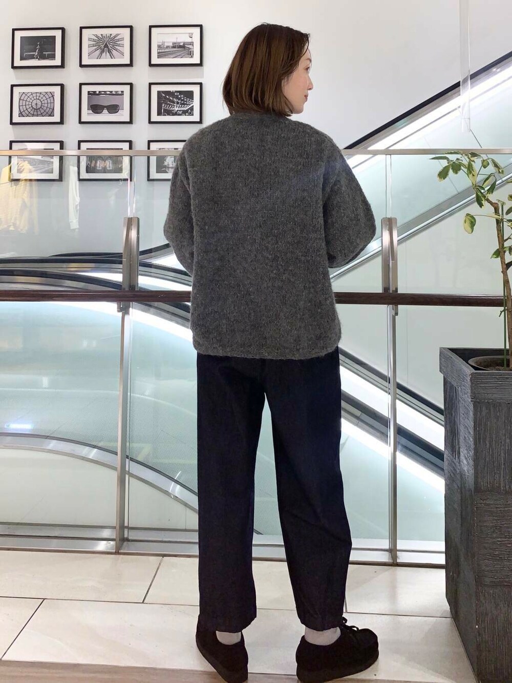 グレー系のカーディガン/ボレロ、レッド系のTシャツ/カットソー、ブルー系のデニムパンツを着用したレディースの冬コーディネートの3枚目の写真