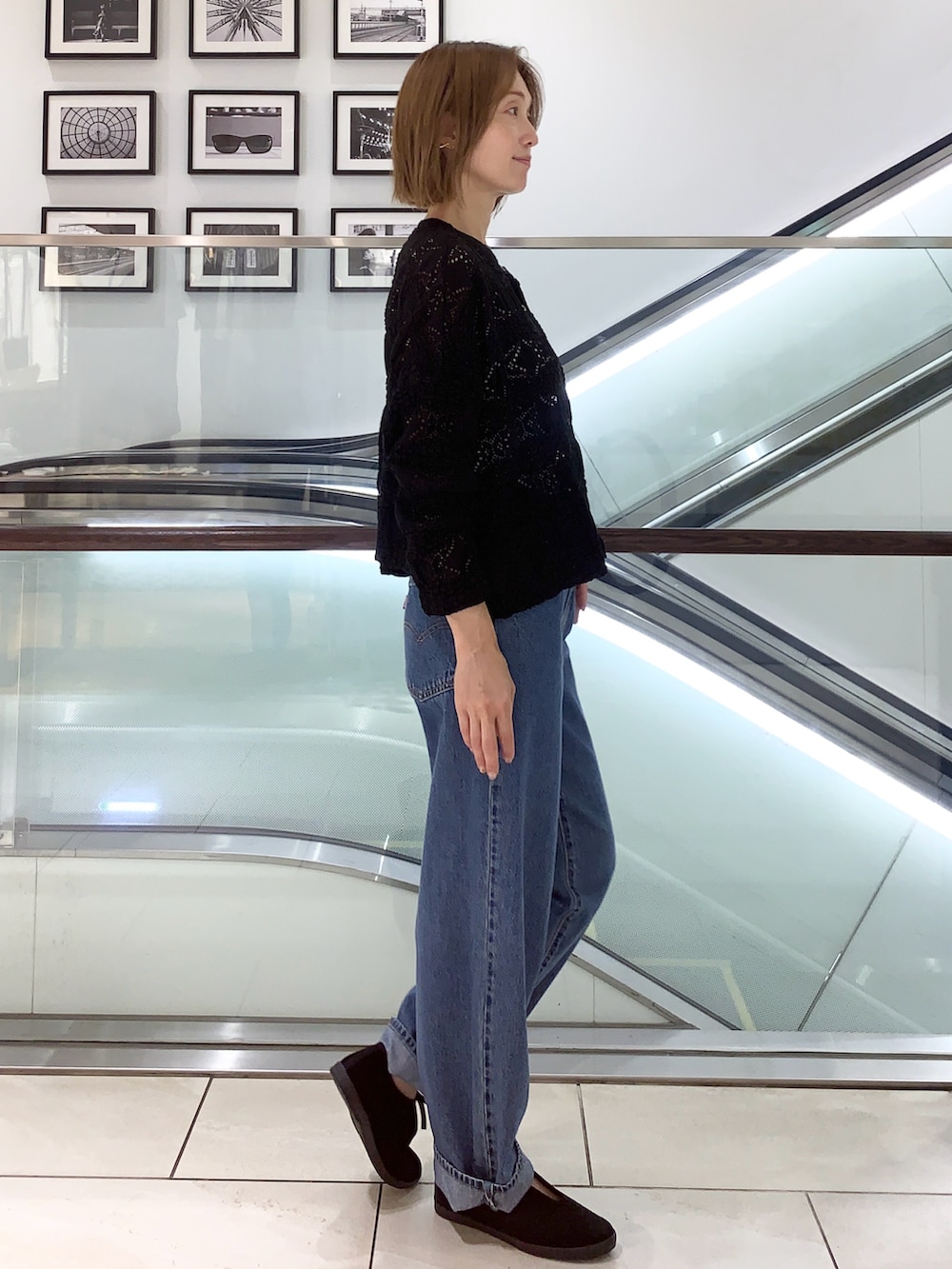 ブルー系のデニムパンツ、ブラック系のカーディガン/ボレロ、ブラック系のその他シューズを着用したレディースの夏コーディネートの3枚目の写真